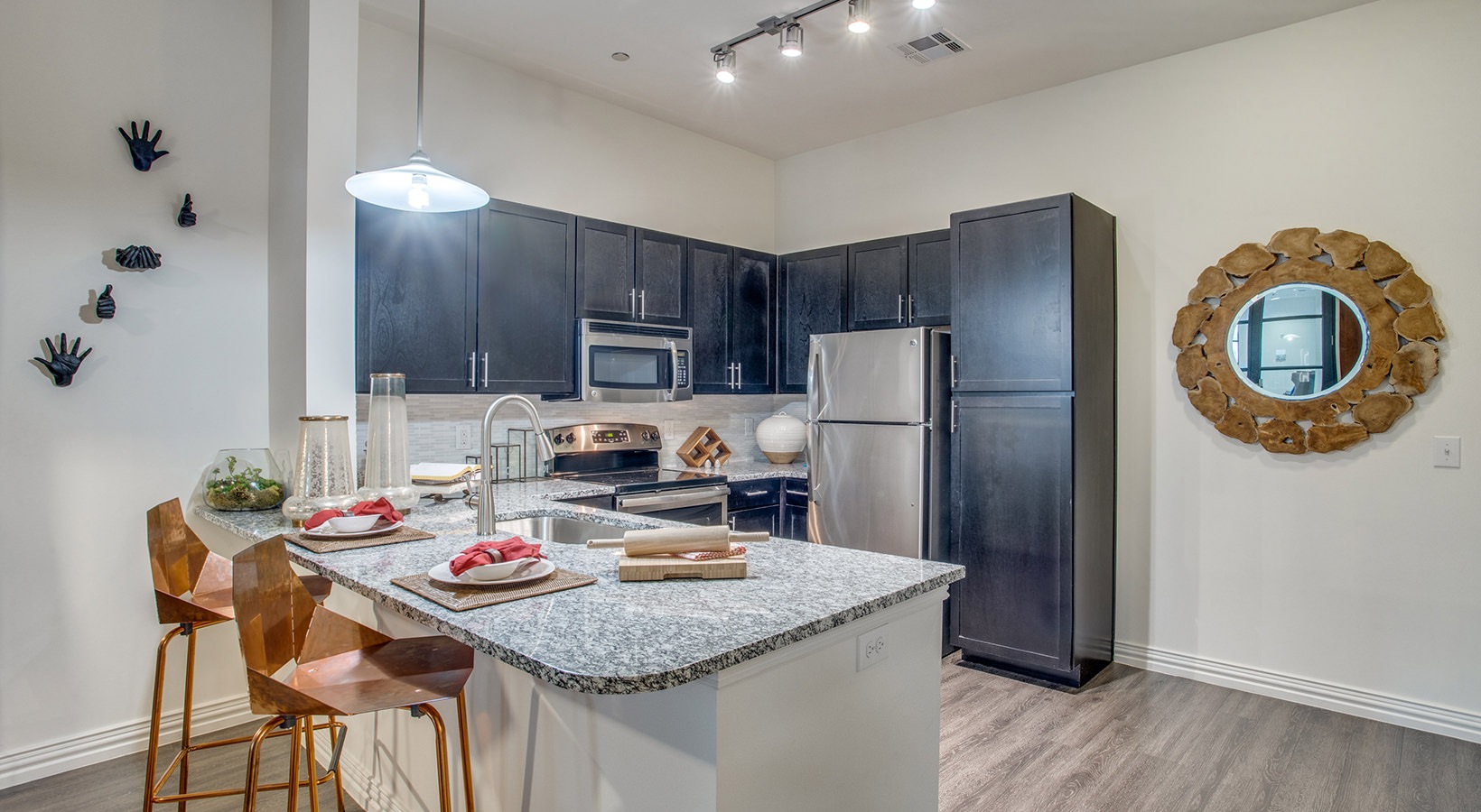 a kitchen with stainless steel appliances and granite countertops at The Twin Creeks Crossing